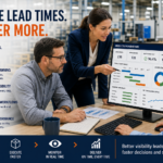 Manufacturing team collaborating around production reports and planning documents in an industrial environment, illustrating how real-time visibility, automated workflows, and ERP software help reduce manufacturing lead times.